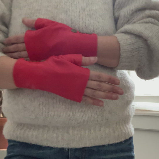 Women  hands  showing how to wear lamia design fingerless red short leather gloves  with 3 bronze snaps 