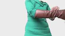 Load and play video in Gallery viewer, woman with a green dress showing  brown fingerless leather gloves handmade by lamia design
