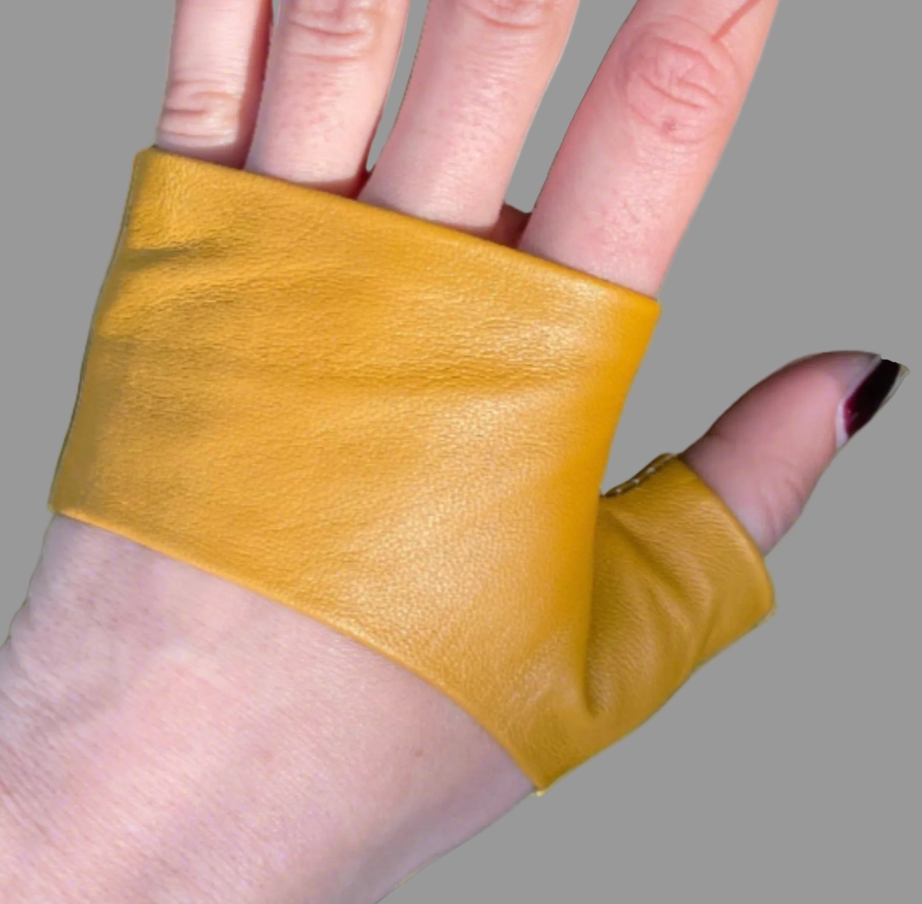a hand wearing lamia design Mastard mini Gloves in leather Handmade Accessories