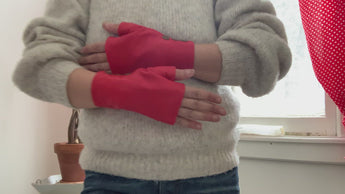 Women  hands  showing how to wear lamia design fingerless red short leather gloves  with 3 bronze snaps 