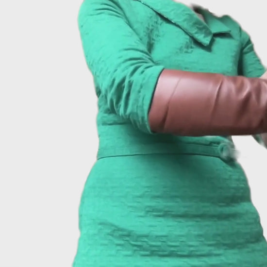 woman with a green dress showing  brown fingerless leather gloves handmade by lamia design